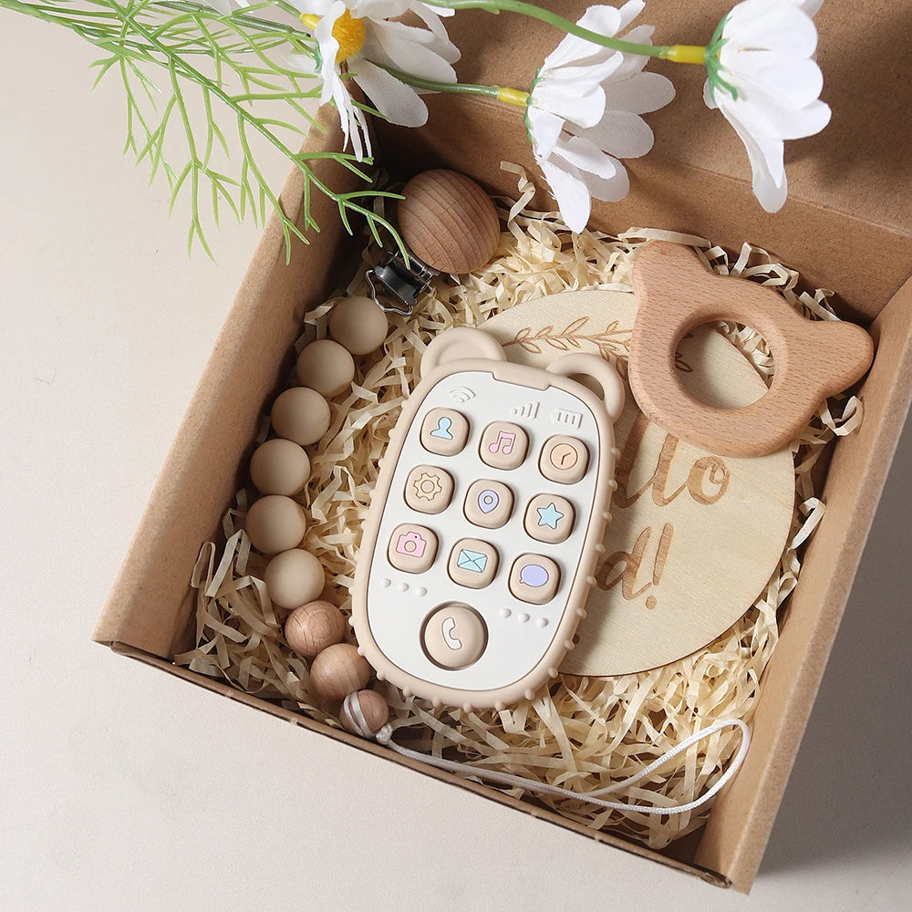 Wooden baby teether, and teether with buttons in a box with flowers