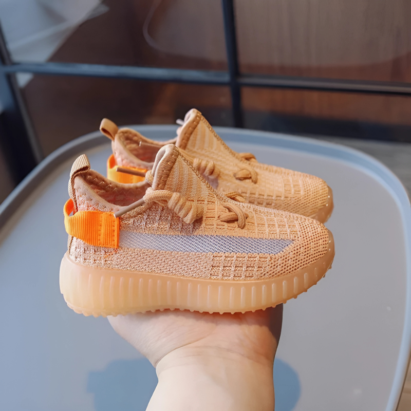a hand holding out a pair of Breathable Toddler Knit Sneakers – Lightweight, Non-Slip Shoes for Toddlers