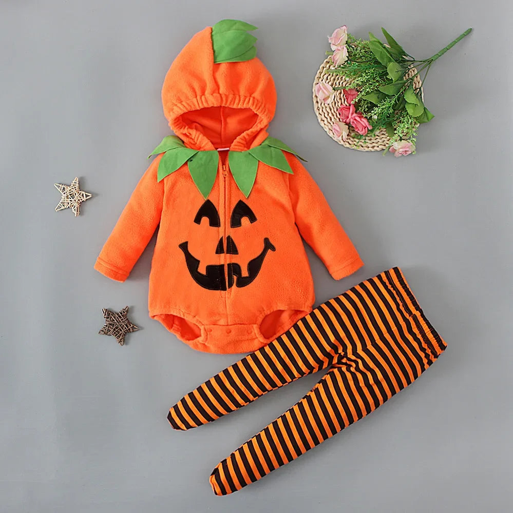 Halloween-themed baby outfit with pumpkin design and striped leggings on a gray background.