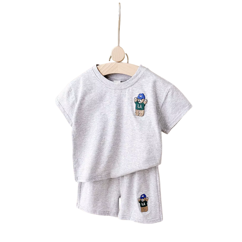 Gray children's t-shirt and shorts set with character patches on a white background