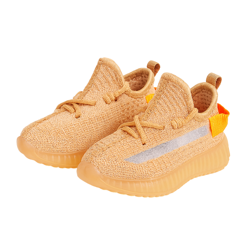 Peach coloured knit sneakers on a white background