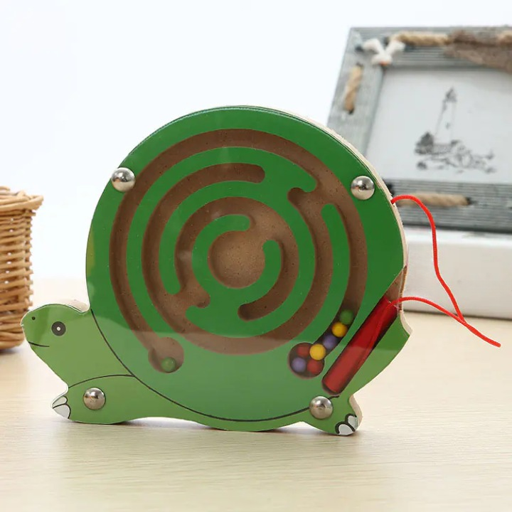 Green Turtle-shaped maze toy on a light surface with a blurred background