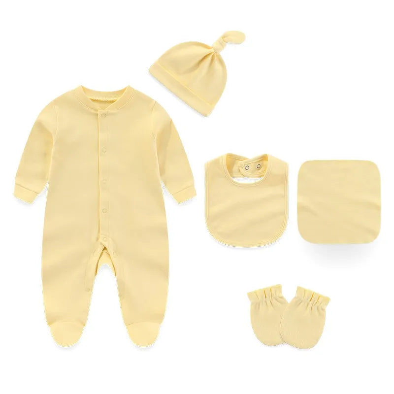 Yellow baby outfit set with onesie, hat, bib, burp cloth, and mittens on a white background