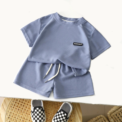 Children's blue outfit with shorts and a checkered shoe on a white background
