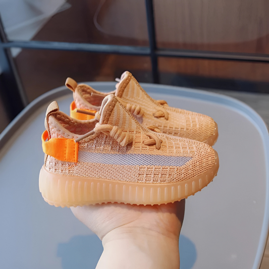 a hand holding out a pair of Breathable Toddler Knit Sneakers – Lightweight, Non-Slip Shoes for Toddlers