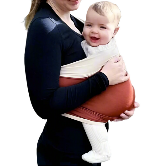 Baby smiling while carried by their mommy in the BabyCarry sling wrap, showing happy bonding and comfortable wear.

