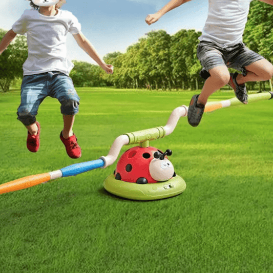 Children playing with a ladybug-shaped toy on a grassy field