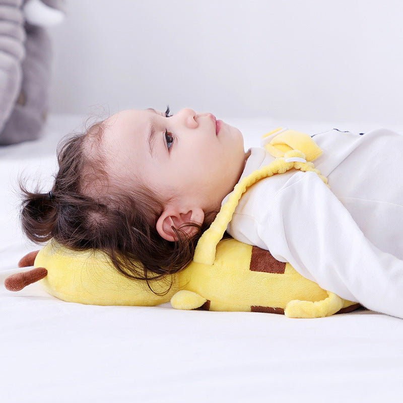 Child lying on a shock-absorbing infant head support pillow in cute bee style