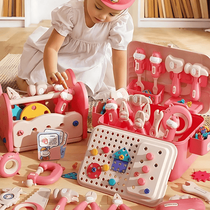 Child playing with a pink toy set on a wooden floor