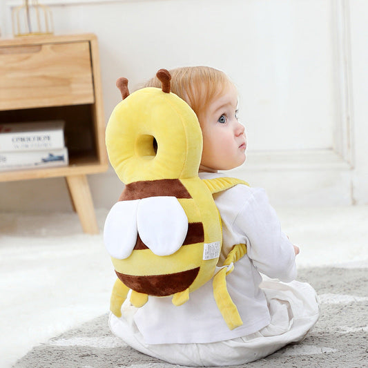 Baby wearing soft breathable head protector while sitting on floor
