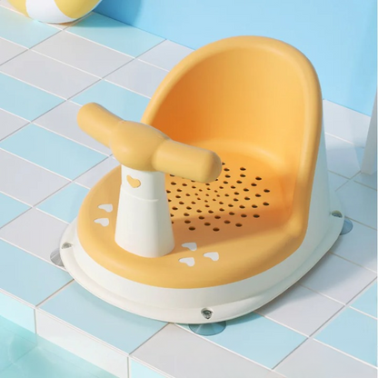 Yellow bath seat with white handle on a tiled bathroom floor