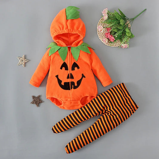 Halloween-themed baby outfit with pumpkin design and striped leggings on a gray background.