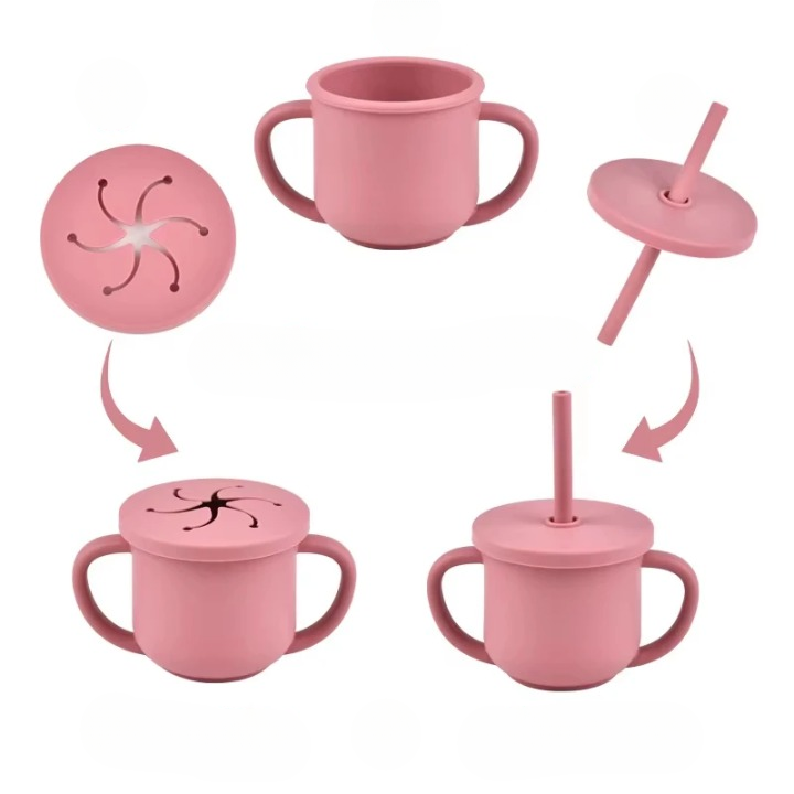 Set of pink sippy cups with various lids and straws on a white background