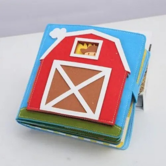 Farmyard Felt storybook with a red barn illustration on a white background