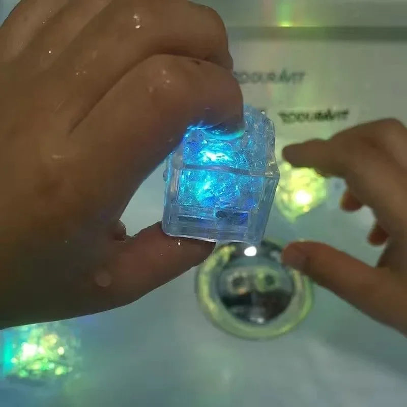 Clear glowing cube held by hands with a blurred background