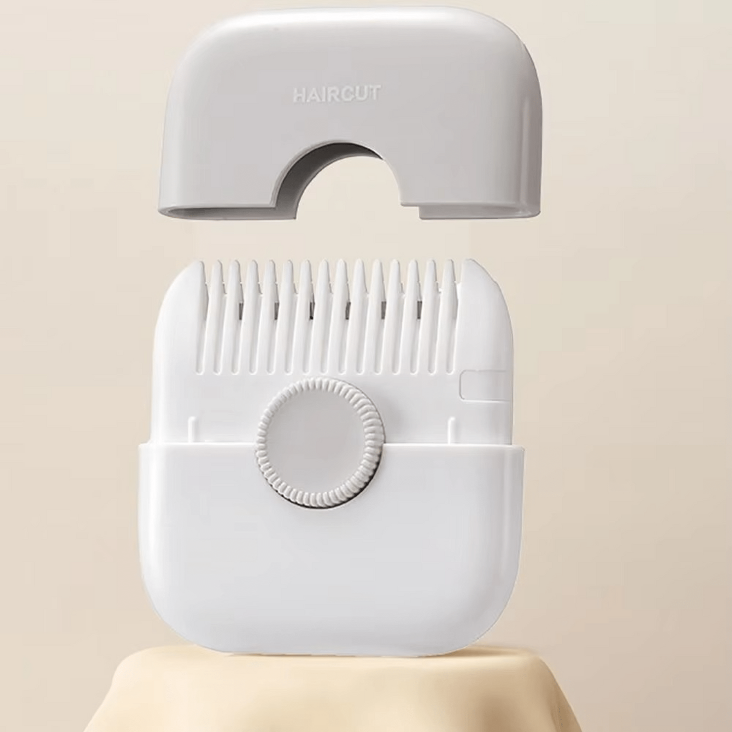 Gray hair clipper on a beige background