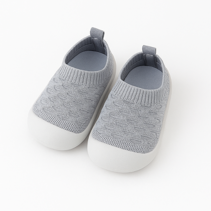 gray knit baby shoes on a white background