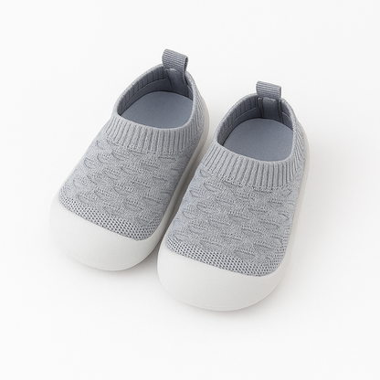 gray knit baby shoes on a white background