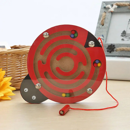 Wooden maze toy with colorful beads on a wooden surface