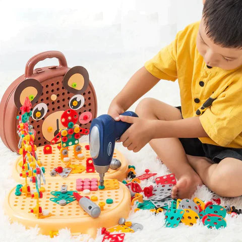 Child playing with a toy screw driver and colorful building blocks on a white surface.