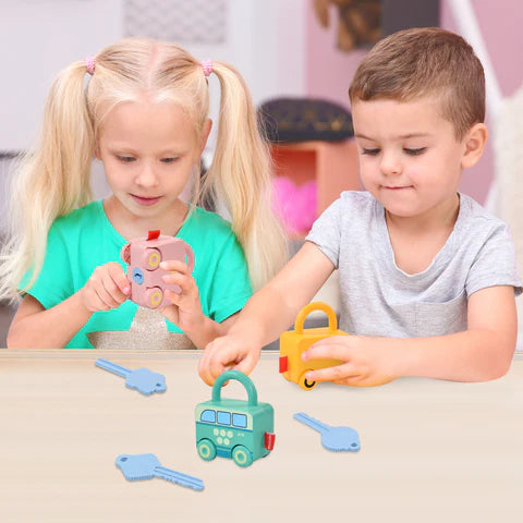 Two children playing with colorful toy keys and a toy car at a table.