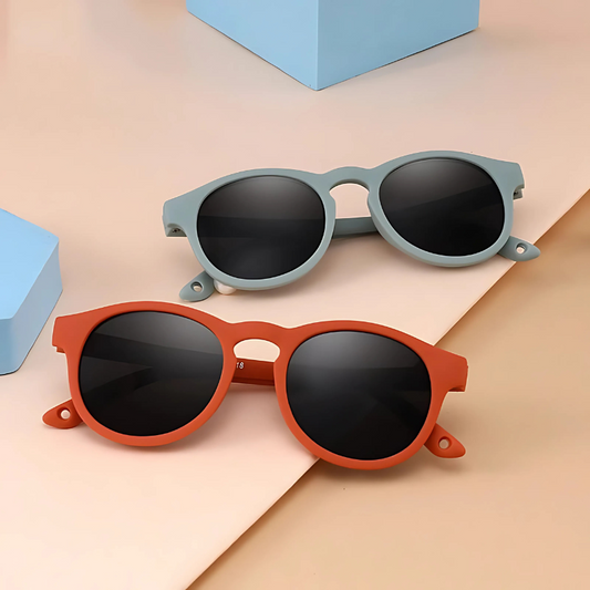 orange and blue colored kids sun glasses on a white background