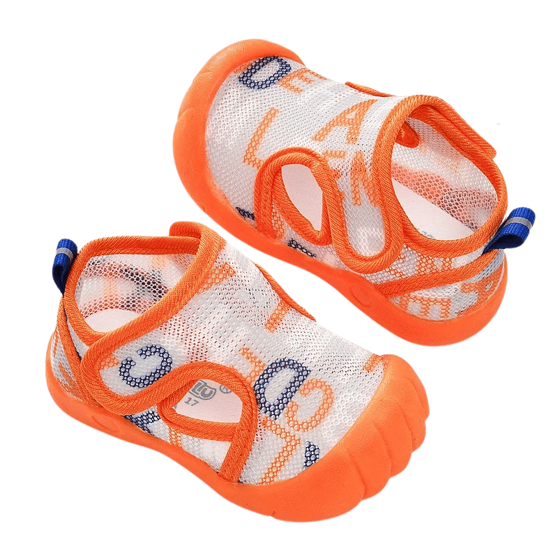 orange mesh baby shoes on a white background