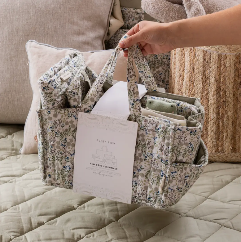Floral-patterned bag with a book on a bed