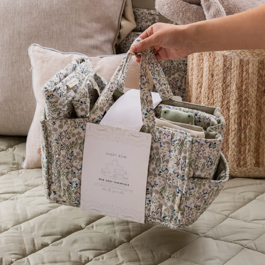 Floral-patterned bag with a book on a bed