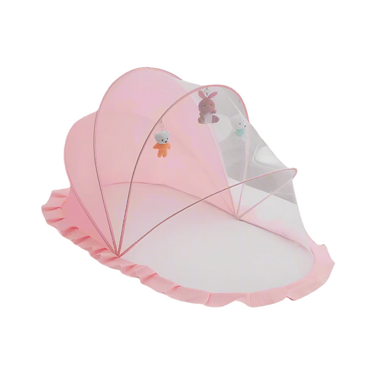 Pink NapCloud mosquito net set up over a soft surface, showcasing its playful whale shape and breathable mesh for baby comfort.