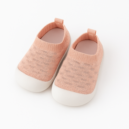 pink knit baby shoes on a white background