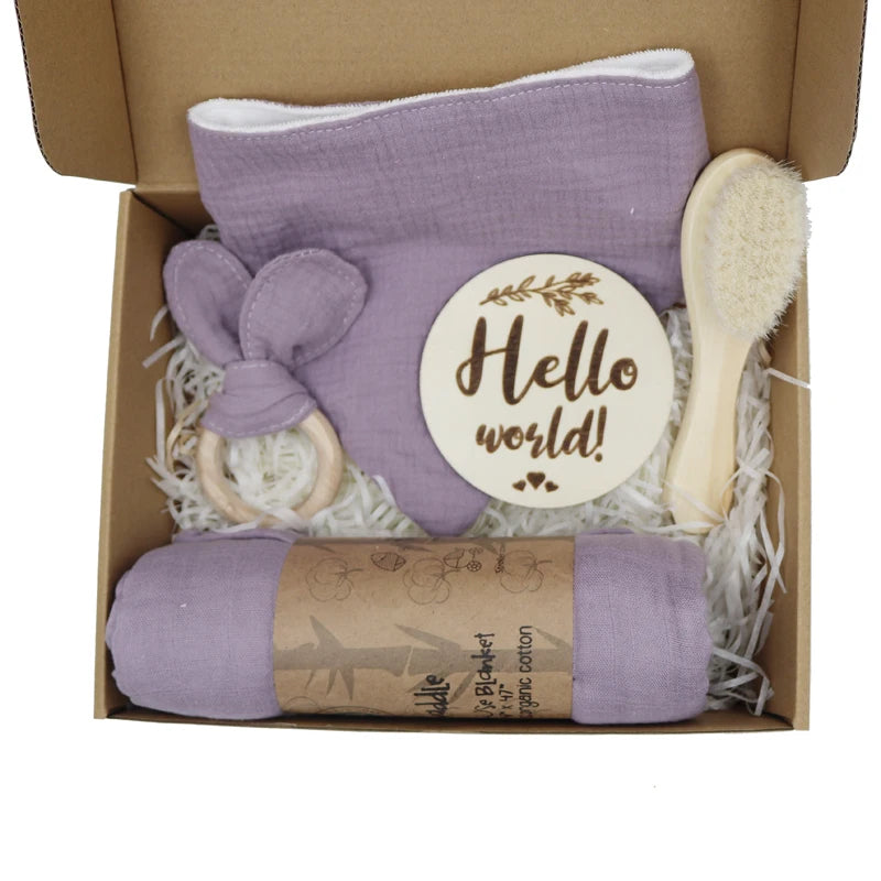 Baby gift set with purple blanket, brush, Teether, and 'Hello world!' card in a box.