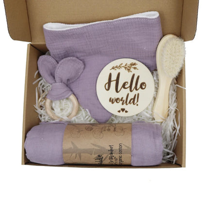 Baby gift set with purple blanket, brush, Teether, and 'Hello world!' card in a box.
