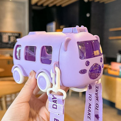 Purple water bottle & toy bus with a lanyard held by a hand in an indoor setting