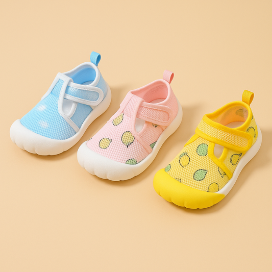 3 coloured mesh baby shoes on a beige background
