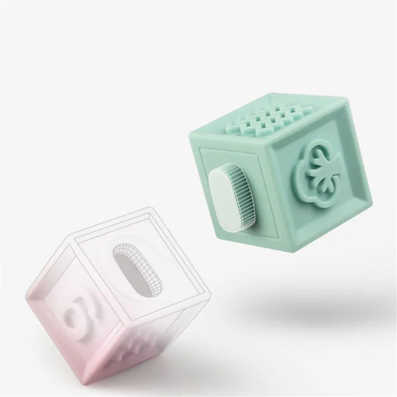Two cube-shaped objects, one green and one pink, on a white background