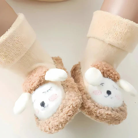 Pair of beige socks with cartoon character feet on a light background