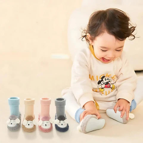 Child wearing  colorful socks on a light background