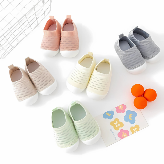 a display of SnuggzKnit baby shoes on a white background