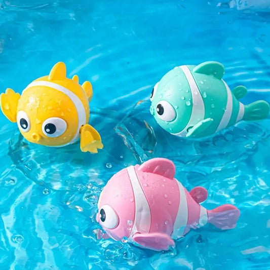 Three colorful fish-shaped toys floating in clear blue water.