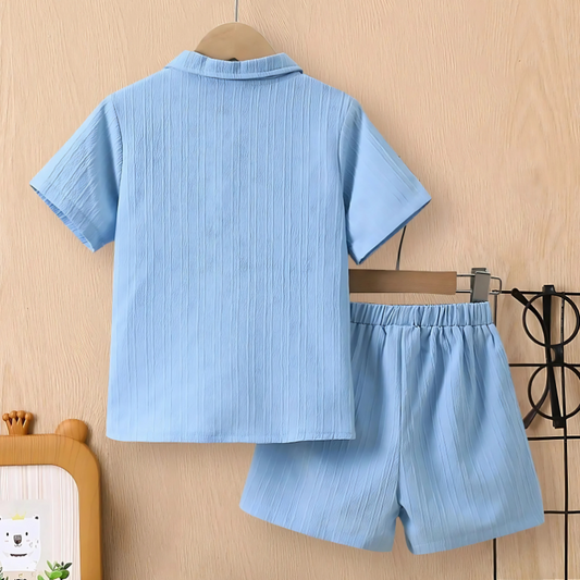 Children's blue shirt and shorts set on a beige background