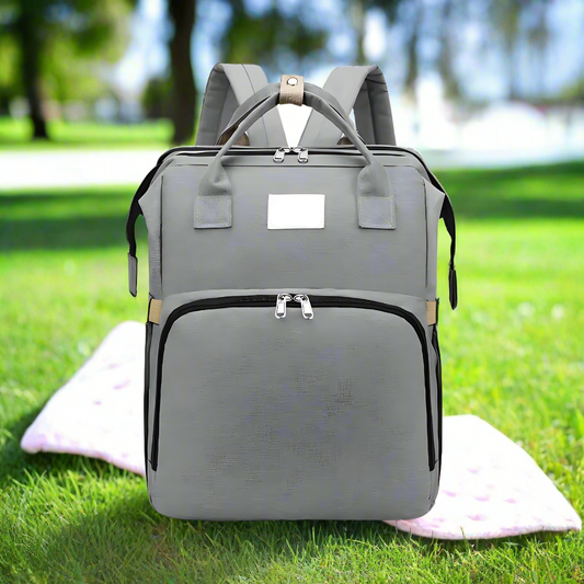 Trekaroo baby backpack in stylish grey, shown upright with zipped compartments and durable fabric texture visible.