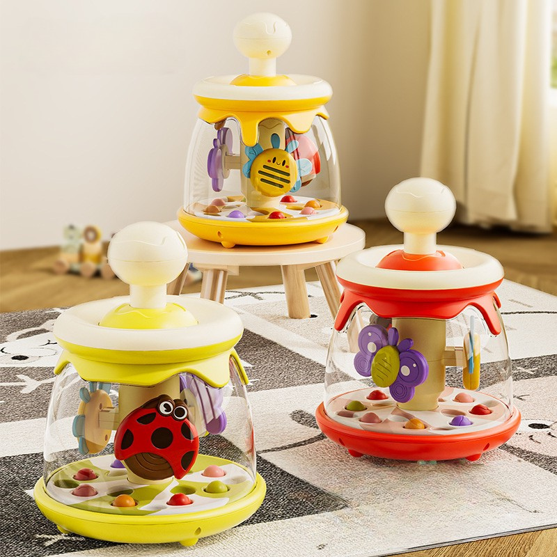 Colorful baby toys with transparent sections on a carpeted floor.