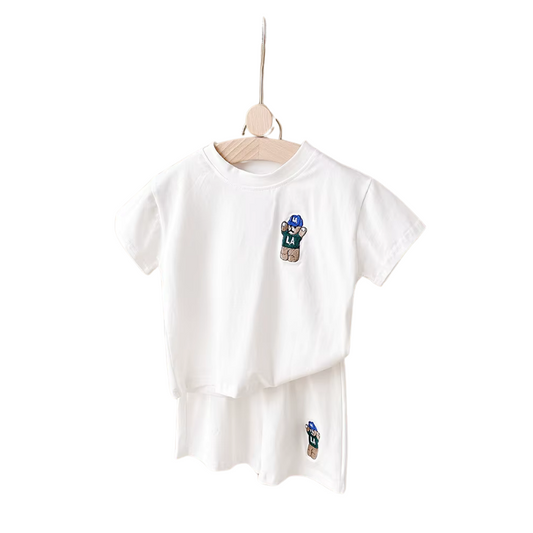 White t-shirt and shorts matching set with bear designs on a hanger against a white background