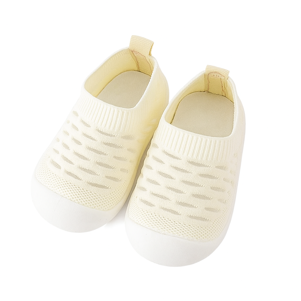 yellow knit baby shoes on a white background