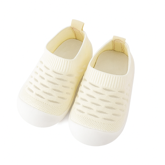 yellow knit baby shoes on a white background
