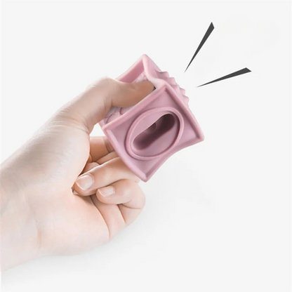Hand holding a pink silicone block against a white background