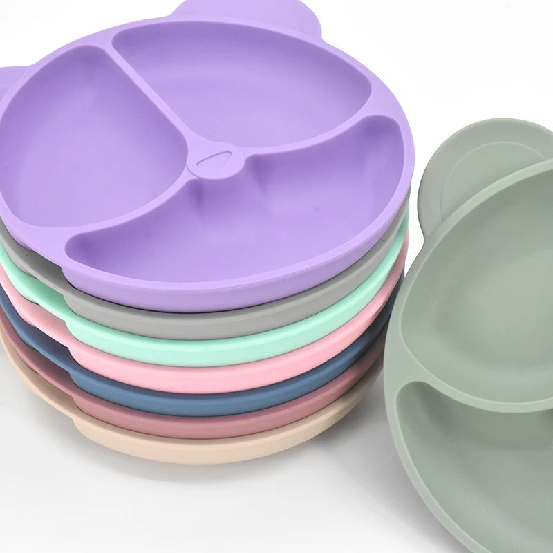 Stack of colorful silicone plates on a white background